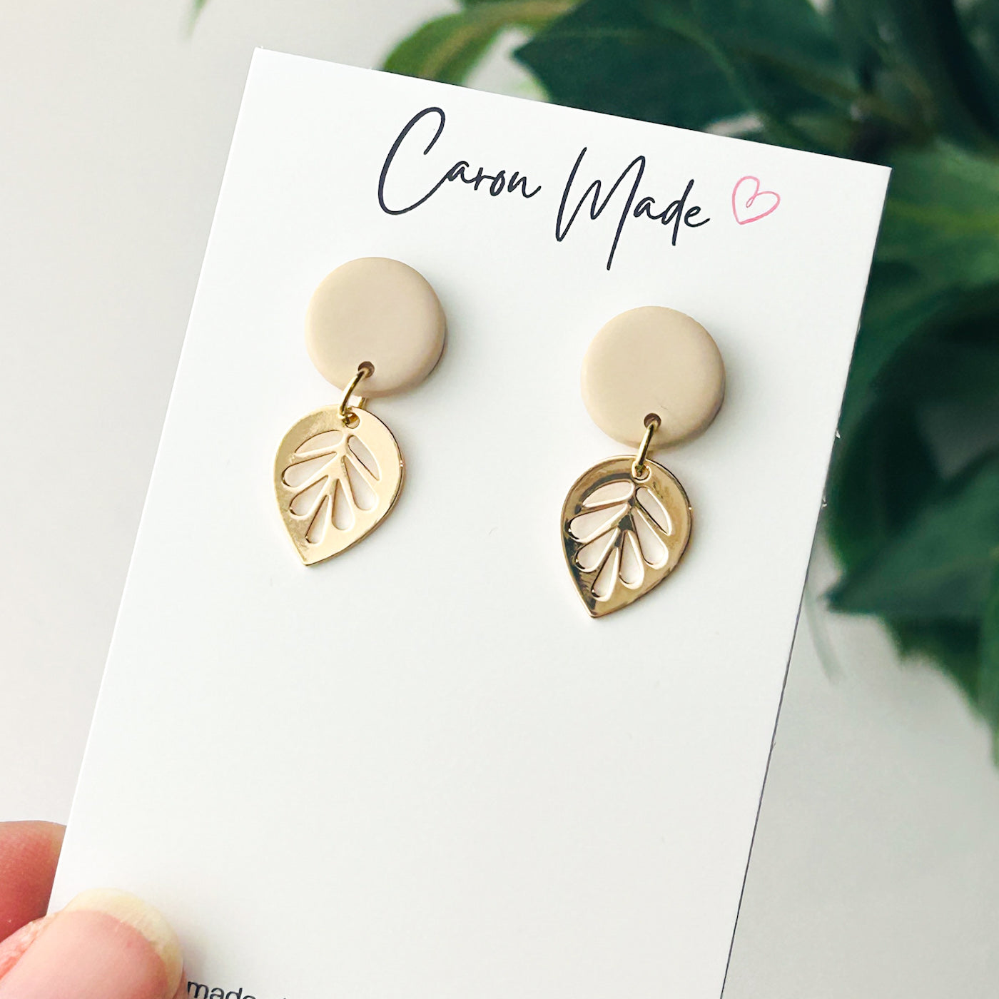 Small beige neutral stud and gold plated leaf earrings