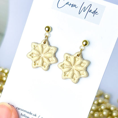 Light gold and beige snowflake dangle earrings