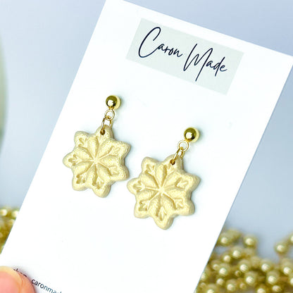 Light gold and beige snowflake dangle earrings