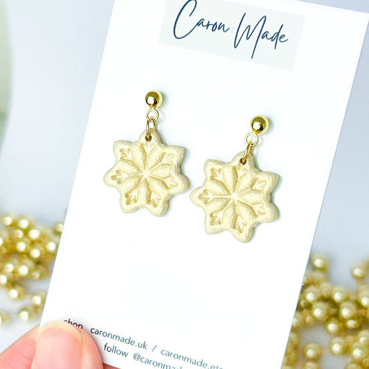 Light gold and beige snowflake dangle earrings